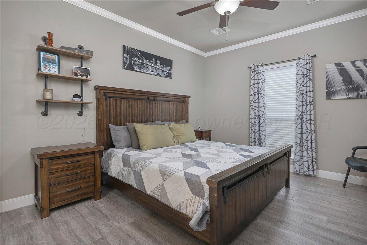 39 Cm Lane Canyon, TX 79015 - Photo 11 of 26 a bedroom with a bed and a chandelier