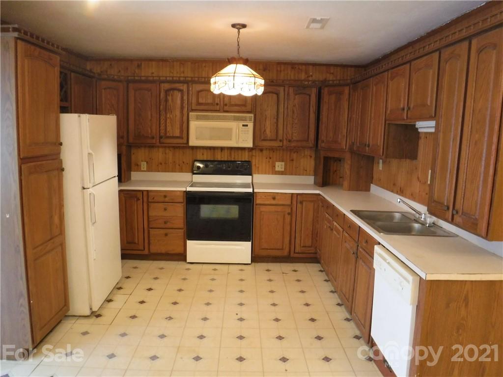 4221 Maple Creek Road Rutherfordton, NC 28139 - Photo 11 of 48 a kitchen with stainless steel appliances a refrigerator a sink a stove a microwave and island