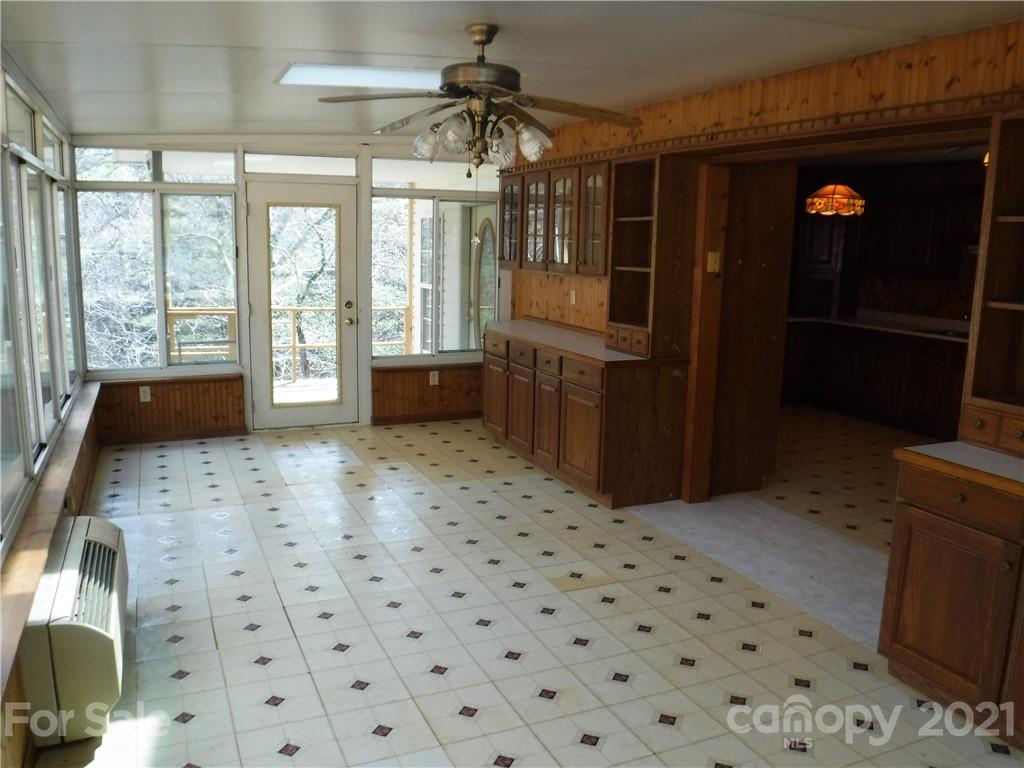 4221 Maple Creek Road Rutherfordton, NC 28139 - Photo 14 of 48 a living room with a black white checkered floor with a large window
