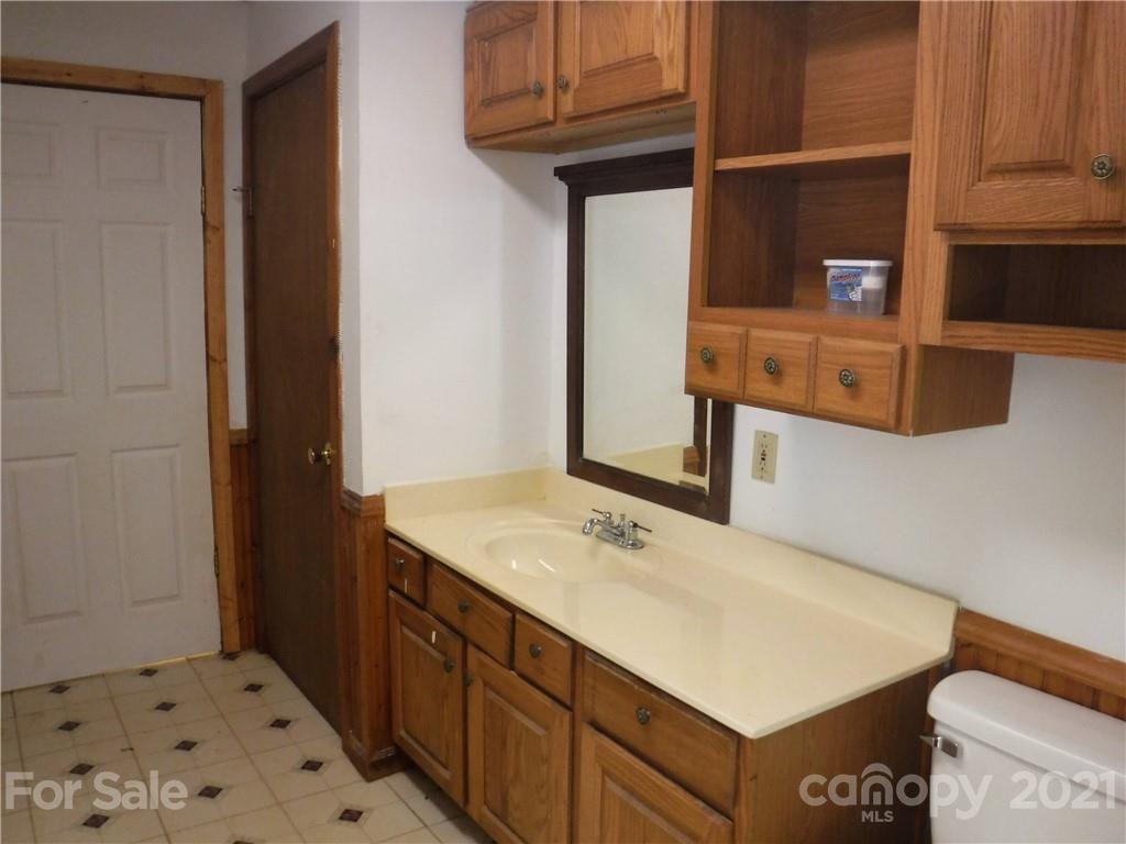 4221 Maple Creek Road Rutherfordton, NC 28139 - Photo 18 of 48 a bathroom with a sink vanity and a mirror