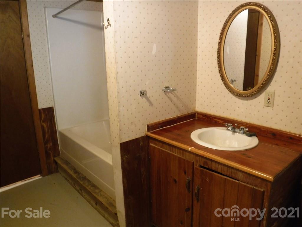 4221 Maple Creek Road Rutherfordton, NC 28139 - Photo 36 of 48 a bathroom with a sink and a mirror