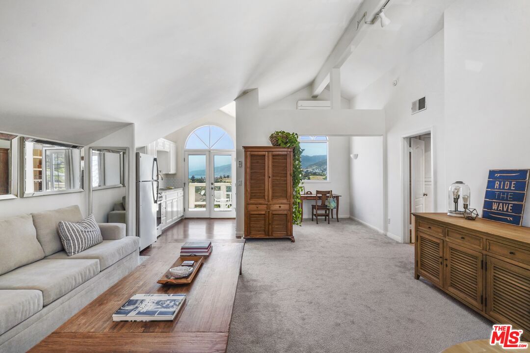 29355 Heathercliff Road, Unit GUESTHOUSE Malibu, CA 90265 - Photo 6 of 26 a living room with furniture and wooden floor