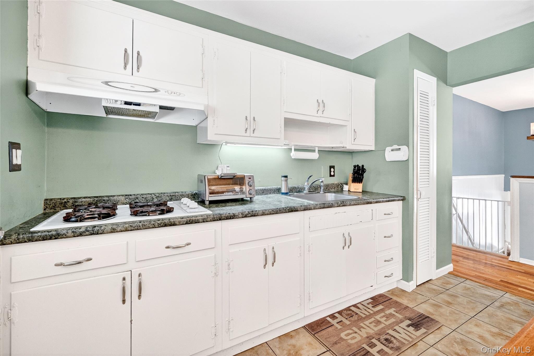 125 Cedar Flats Road Stony Point, NY 10980 - Photo 13 of 48 a kitchen with granite countertop white cabinets and white appliances
