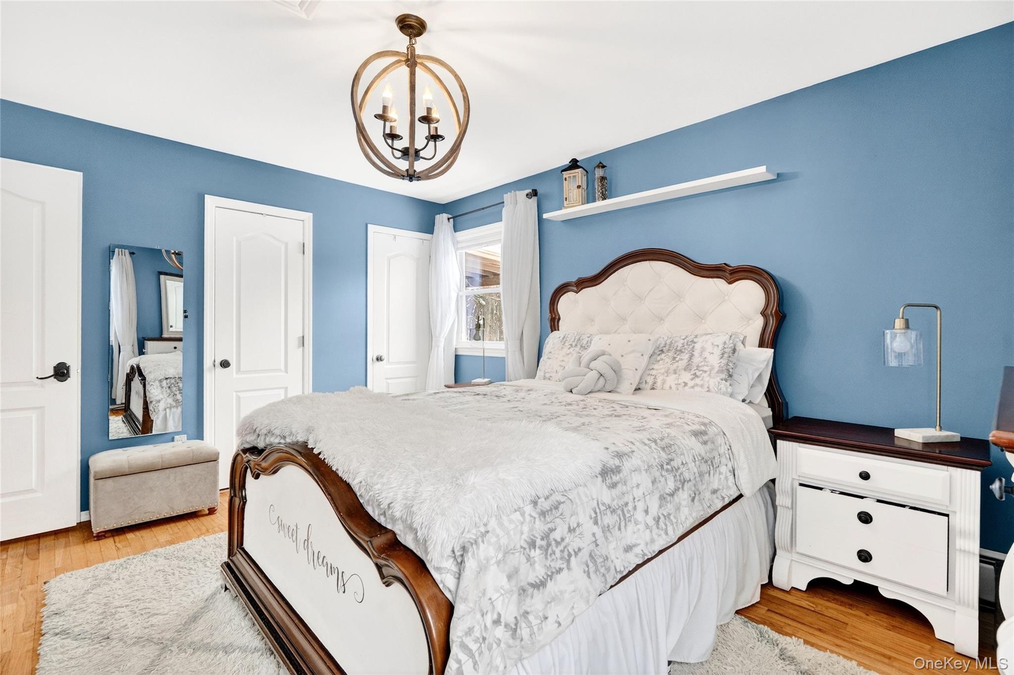 125 Cedar Flats Road Stony Point, NY 10980 - Photo 16 of 48 a bedroom with a bed and a chandelier