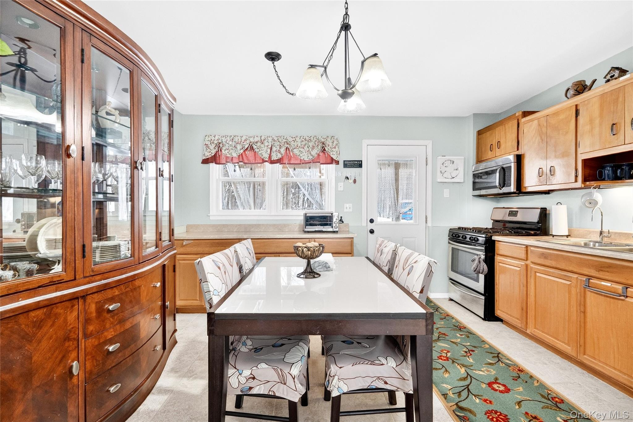 125 Cedar Flats Road Stony Point, NY 10980 - Photo 30 of 48 a kitchen with a table chairs stove and cabinets