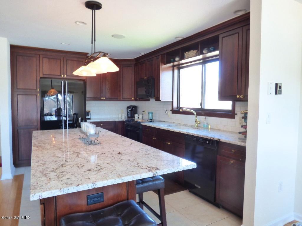 15 River Road, Unit 221 Cos Cob, CT 06807 - Photo 8 of 27 a kitchen with a table and chairs in it