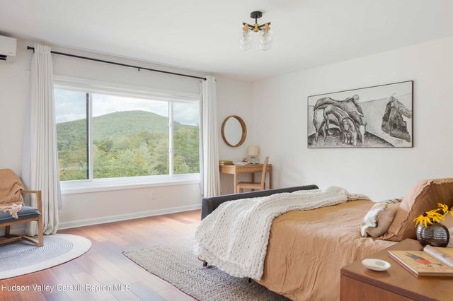 a bedroom with a bed and a large window