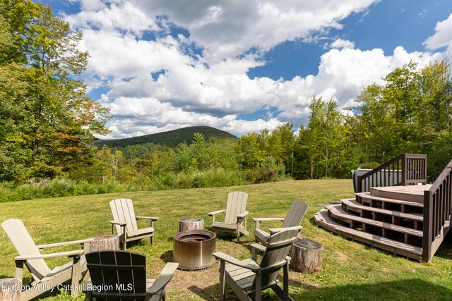 a view of a terrace with lawn chairs