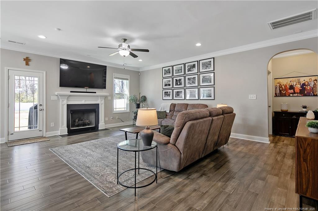 2628 Riddle Farm Road Fayetteville, NC 28306 - Photo 11 of 50 a living room with furniture a flat screen tv and a fireplace