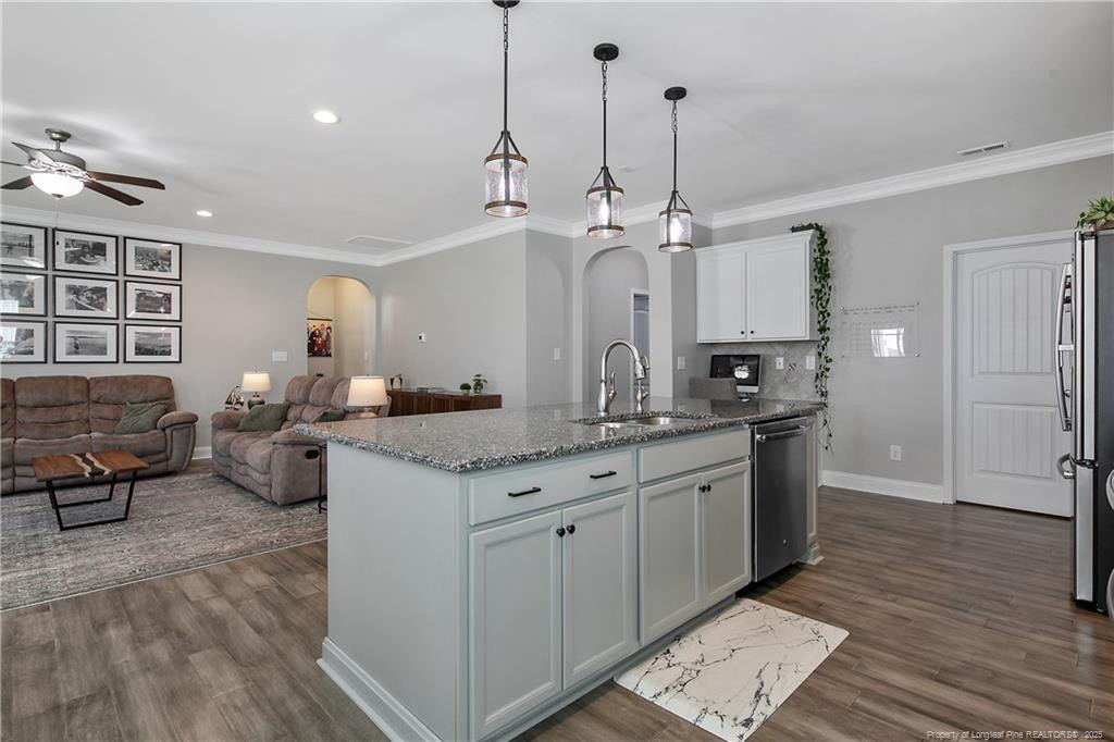 2628 Riddle Farm Road Fayetteville, NC 28306 - Photo 23 of 50 a large kitchen with kitchen island a chandelier stainless steel appliances a sink and wooden floor