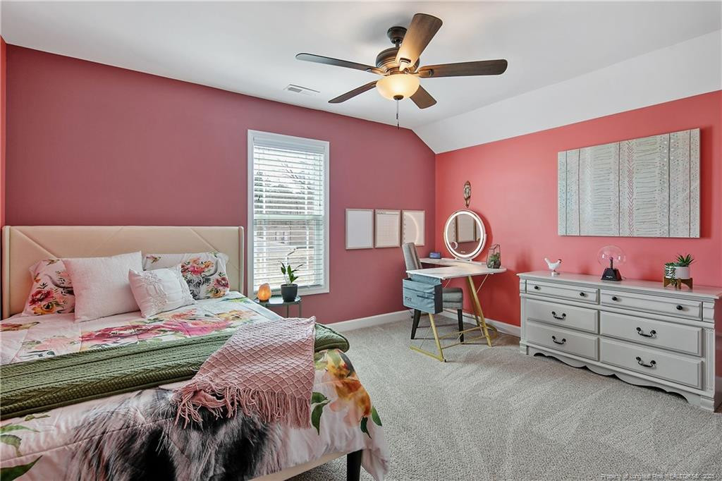 2628 Riddle Farm Road Fayetteville, NC 28306 - Photo 36 of 50 a bedroom with a bed a chandelier and dresser