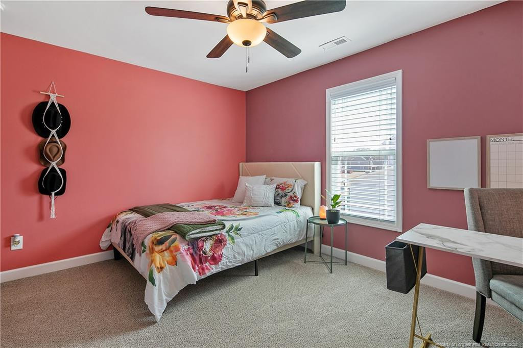 2628 Riddle Farm Road Fayetteville, NC 28306 - Photo 38 of 50 a bedroom with a bed and a window