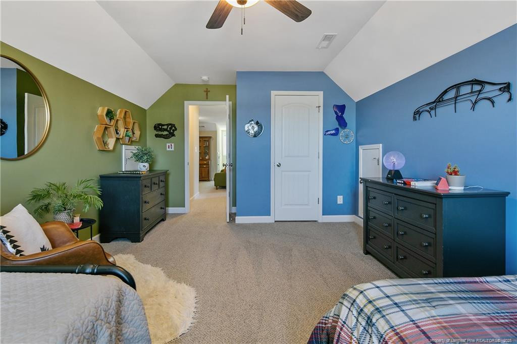 2628 Riddle Farm Road Fayetteville, NC 28306 - Photo 46 of 50 a bedroom with a bed and a chandelier