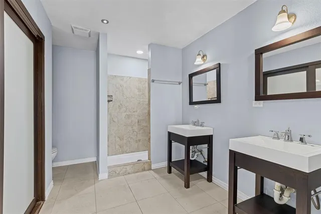 a bathroom with a sink a mirror and a shower