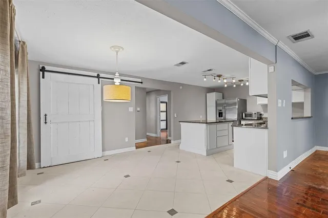 a view of kitchen with furniture and refrigerator