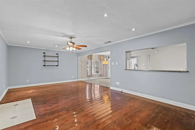a view of an empty room and kitchen