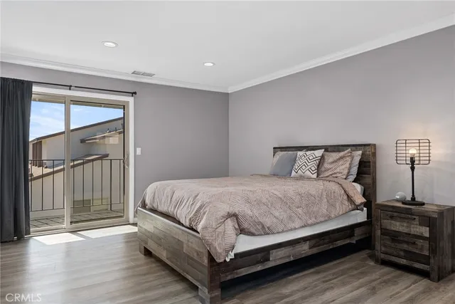 a large bed sitting in a bedroom next to a cabinet