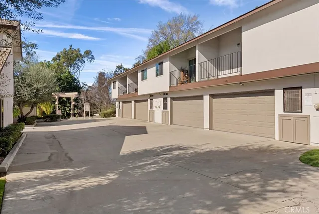 a front view of a house with a road