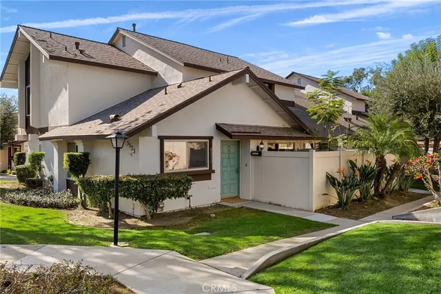 a front view of a house with a yard and outdoor seating