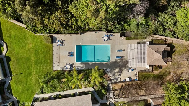 an aerial view of a house with a yard basket ball court and outdoor seating