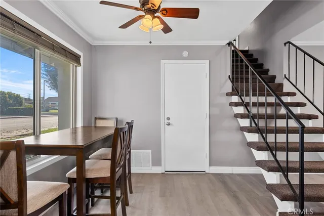 a view of a dining room with furniture and a window