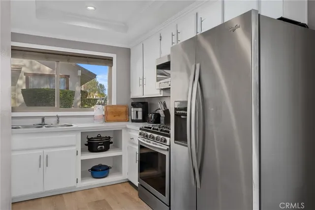 a kitchen with stainless steel appliances a refrigerator stove and sink