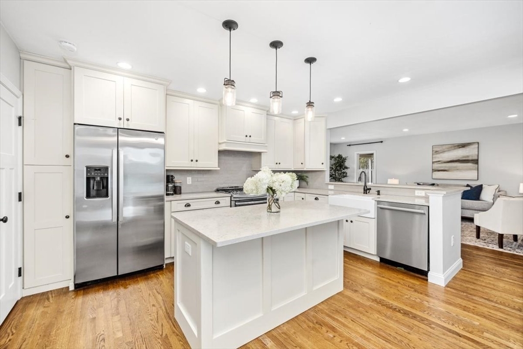 150 High Street Norwell, MA 02061 - Photo 11 of 39 a kitchen with white cabinets appliances and center island