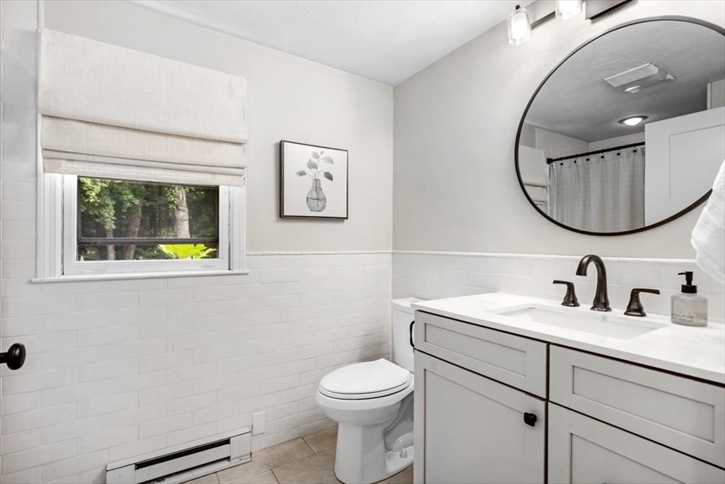 150 High Street Norwell, MA 02061 - Photo 14 of 39 a bathroom with a toilet a sink and mirror
