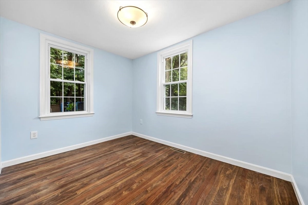 150 High Street Norwell, MA 02061 - Photo 23 of 39 an empty room with wooden floor and windows