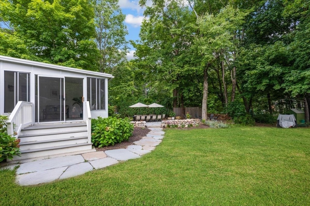 150 High Street Norwell, MA 02061 - Photo 5 of 39 a view of a house with backyard sitting area and garden