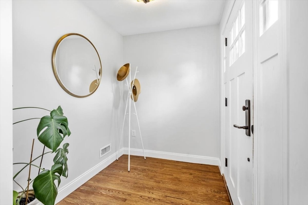 150 High Street Norwell, MA 02061 - Photo 6 of 39 a view of a room with wooden floor and a potted plant