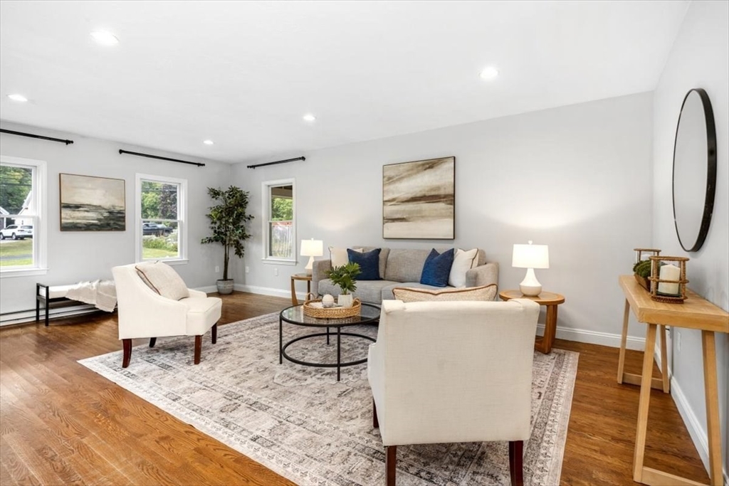 150 High Street Norwell, MA 02061 - Photo 8 of 39 a living room with furniture a rug and a table