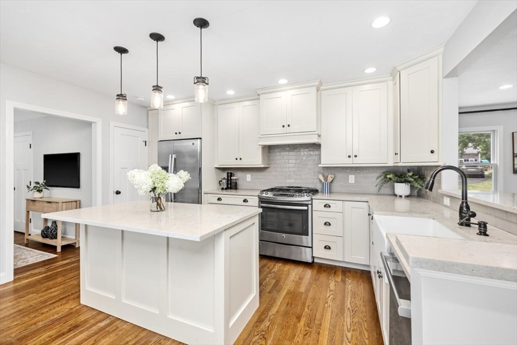 150 High Street Norwell, MA 02061 - Photo 10 of 39 a kitchen with kitchen island white cabinets and white appliances
