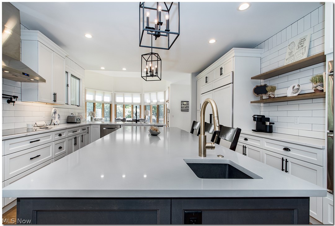 2569 Ginger Wren Road Cleveland, OH 44124 - Photo 13 of 35 GRAPHITE ISLAND WITH STUNNING STATUARIO QUARTZ COUNTERTOP, BAR SINK, HONEY BRONZE GOOSE NECK FAUCET, FOOD DISPOSAL, ROLL-OUTS, BUILT-IN MICROWAVE, OVER HEAD FARMHOUSE LIGHTING, LED SPOT LIGHTS THRU-OUT