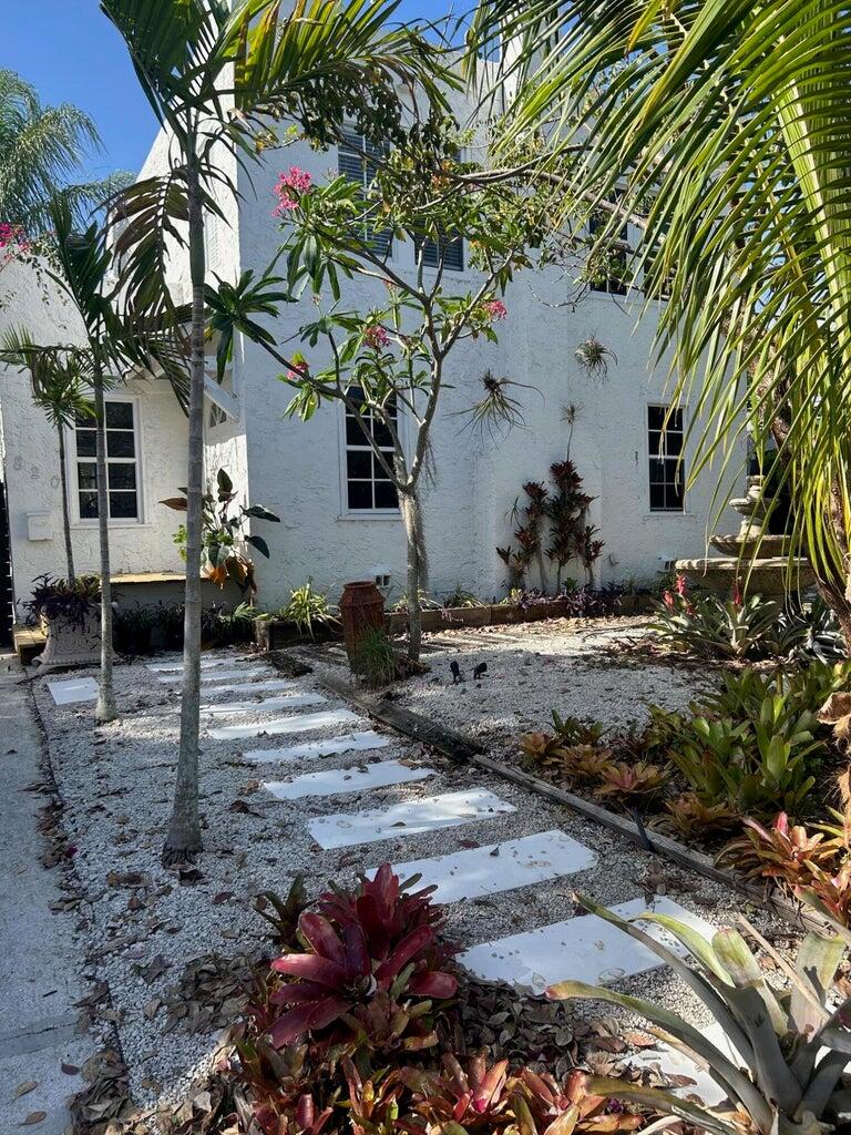 820 30th Street West Palm Beach, FL 33407 - Photo 2 of 40 a backyard of a house with table and chairs under an umbrella