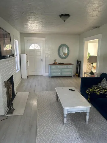 a living room with furniture and a fireplace