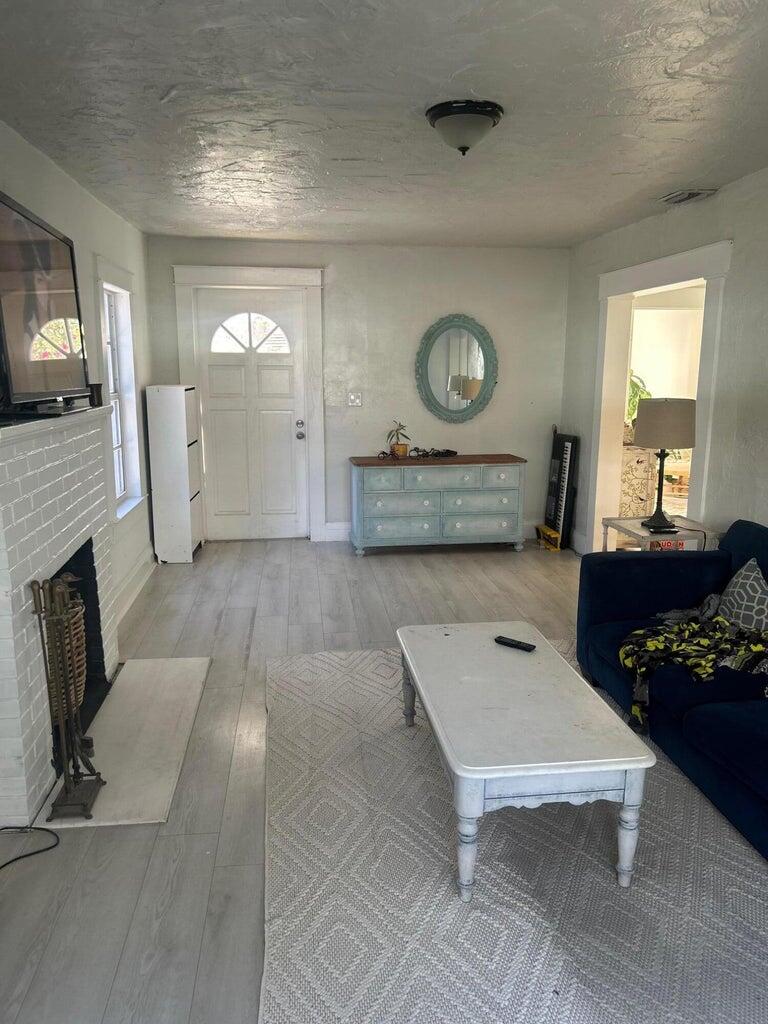 820 30th Street West Palm Beach, FL 33407 - Photo 8 of 40 a living room with furniture and a fireplace