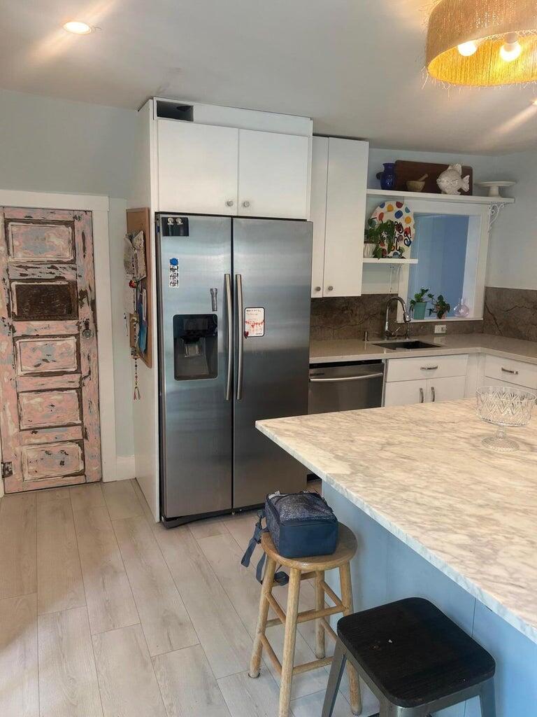 820 30th Street West Palm Beach, FL 33407 - Photo 10 of 40 a kitchen with kitchen island a counter top space cabinets and stainless steel appliances