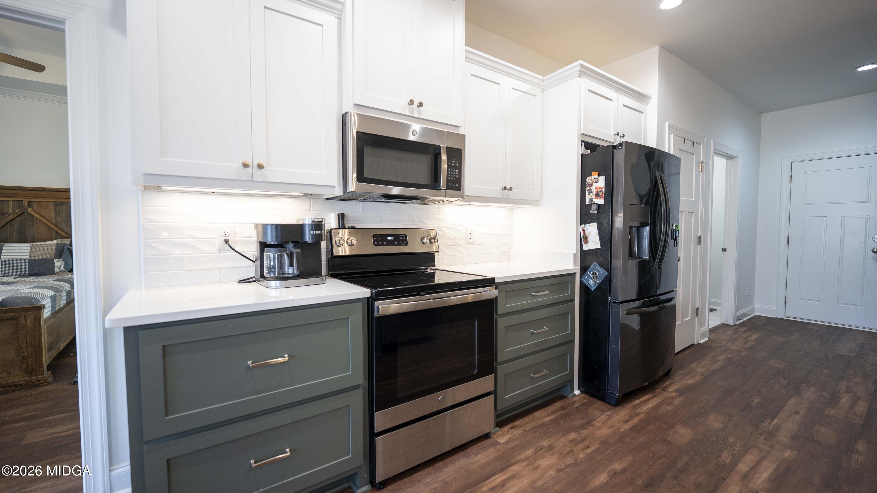 106 Raspberry Trail Perry, GA 31069 - Photo 15 of 42 a kitchen with stainless steel appliances a stove microwave and refrigerator