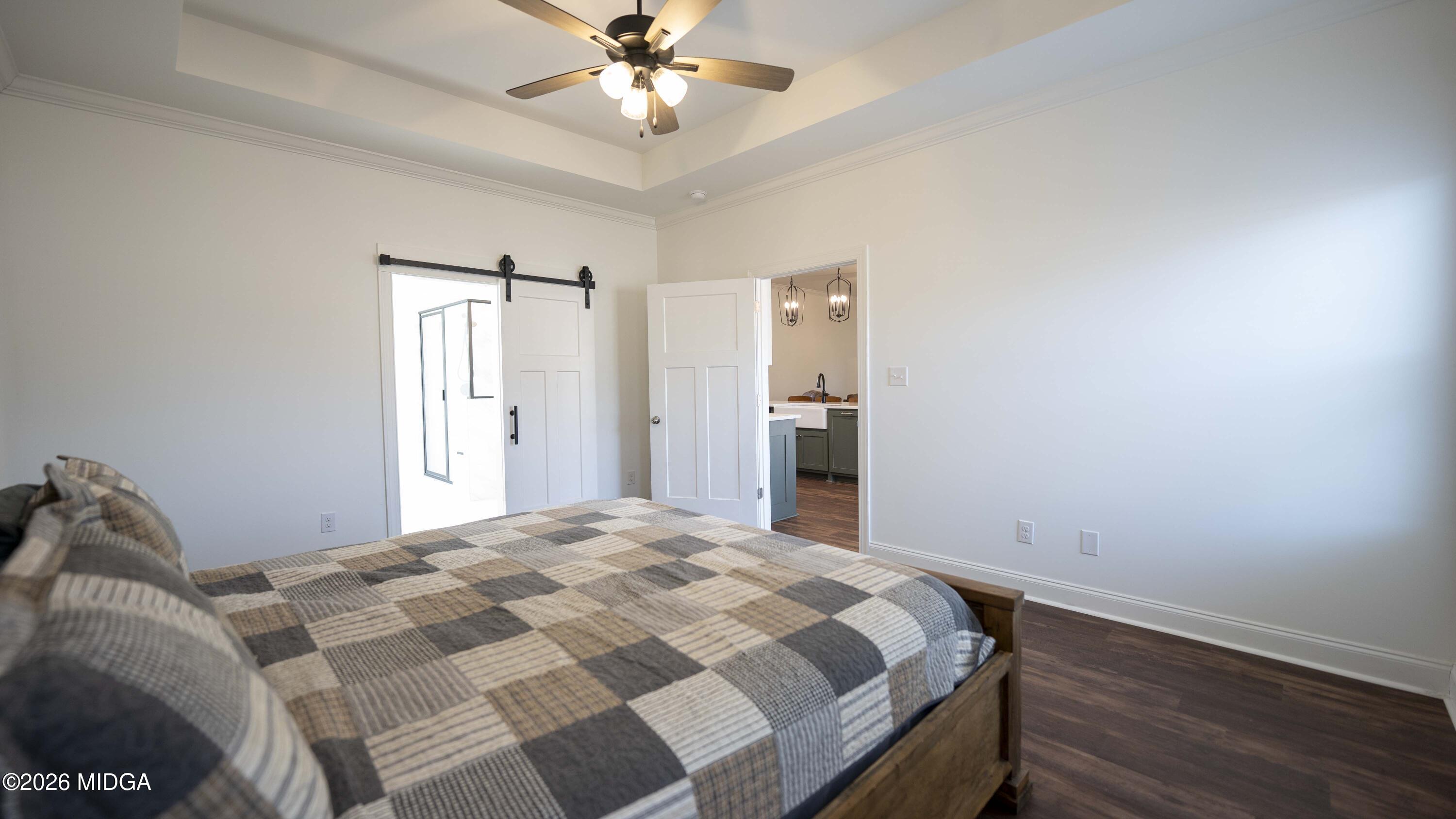 106 Raspberry Trail Perry, GA 31069 - Photo 23 of 42 a bedroom with a bed and a chandelier