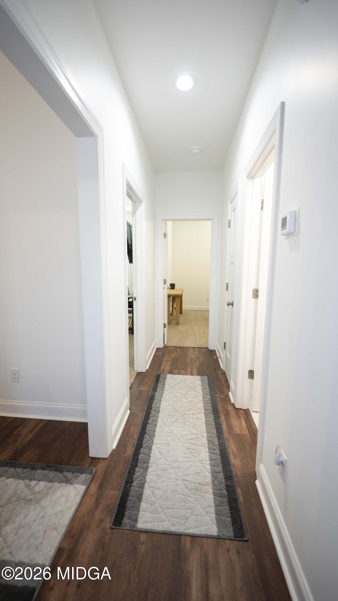 106 Raspberry Trail Perry, GA 31069 - Photo 31 of 42 a view of a hallway with wooden floor and staircase