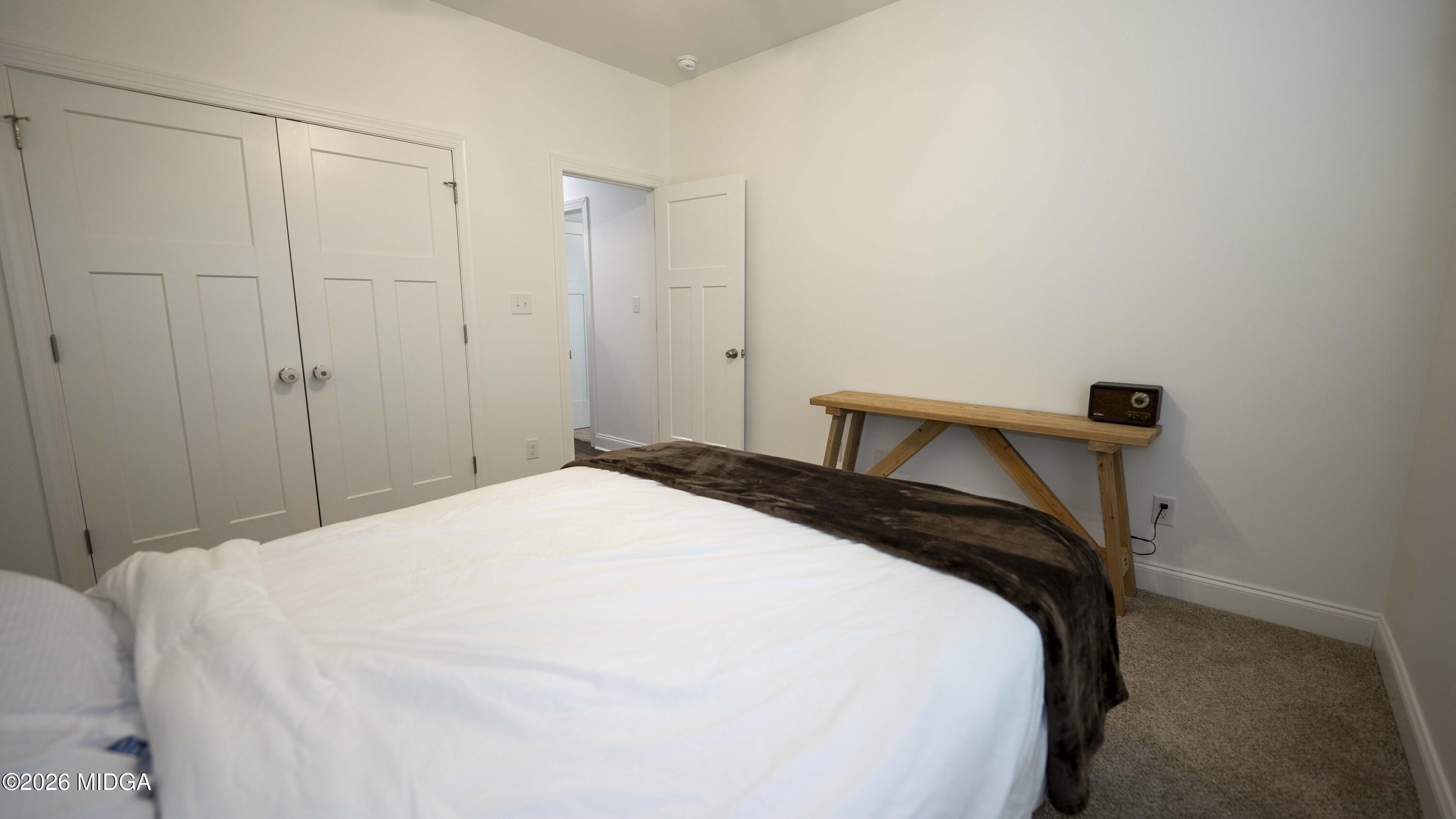 106 Raspberry Trail Perry, GA 31069 - Photo 37 of 42 a bedroom with a bed and a closet