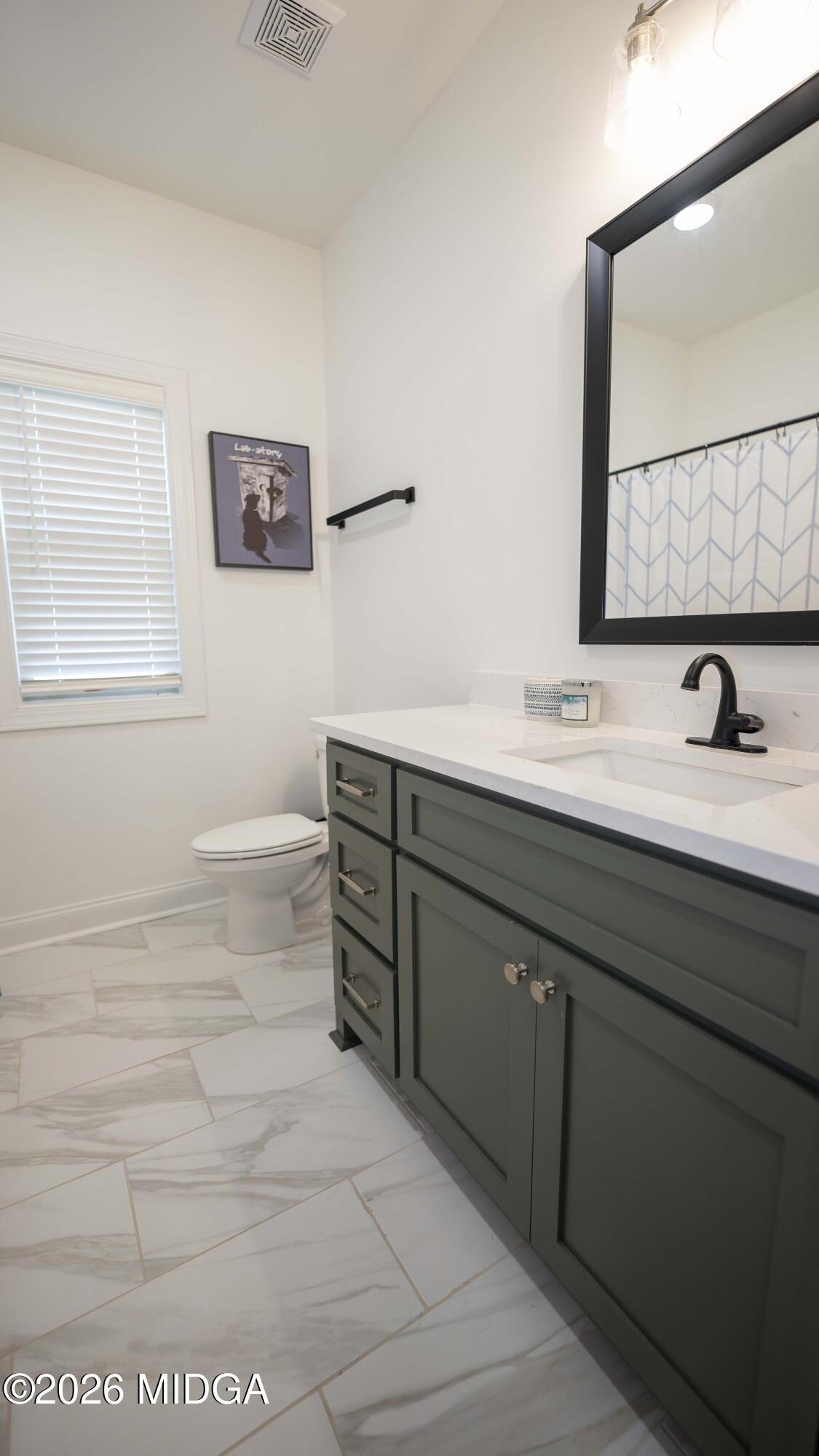 106 Raspberry Trail Perry, GA 31069 - Photo 38 of 42 a bathroom with a sink and a mirror