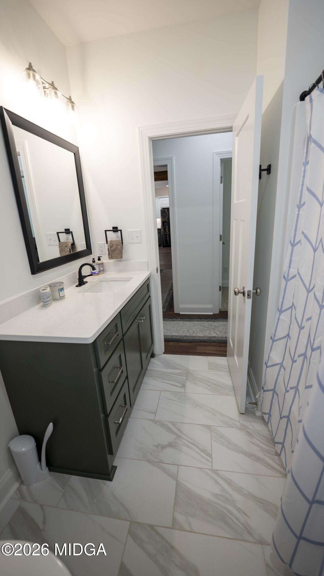 106 Raspberry Trail Perry, GA 31069 - Photo 40 of 42 a bathroom with a sink and mirror