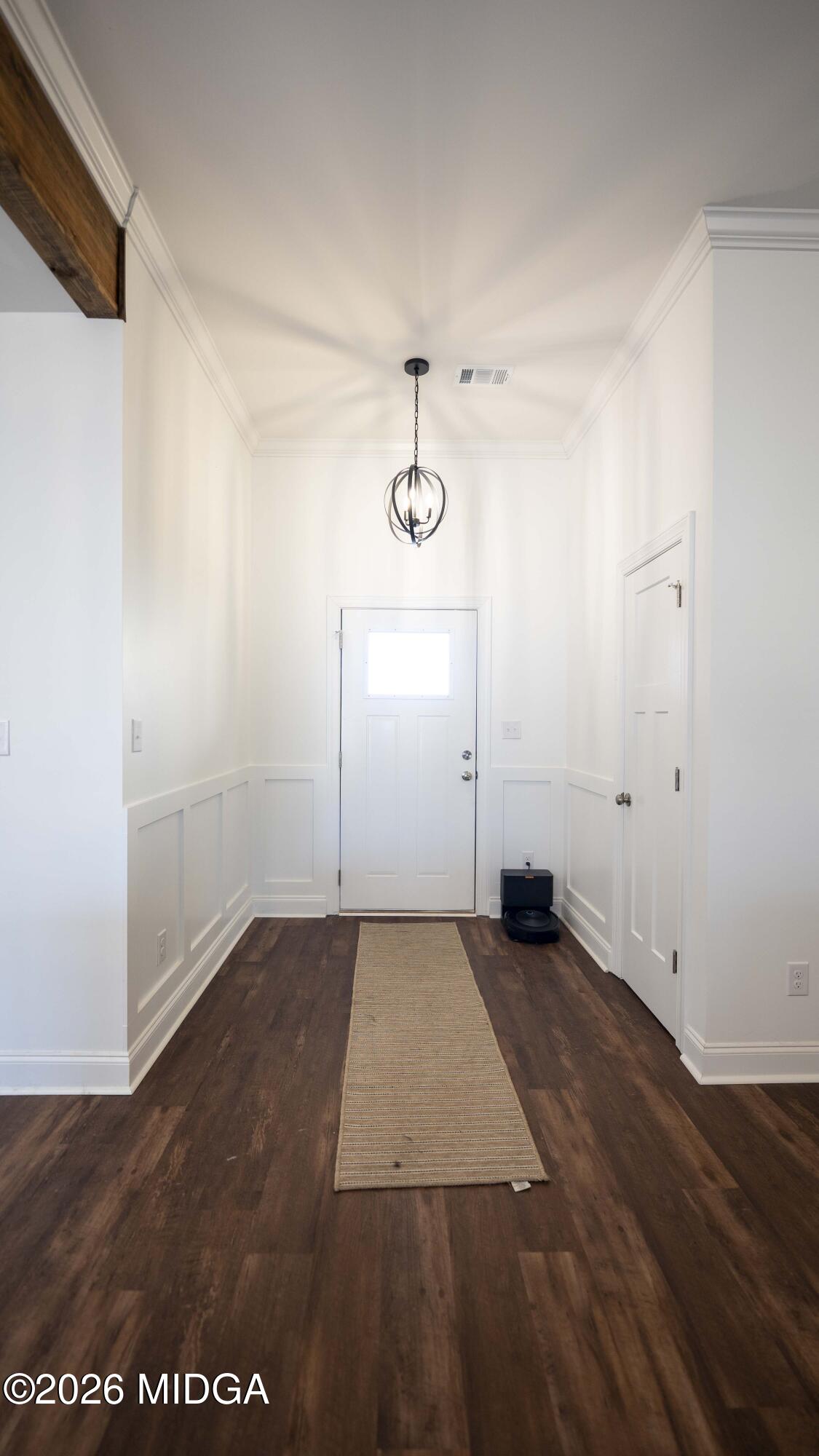 106 Raspberry Trail Perry, GA 31069 - Photo 9 of 42 an empty room with wooden floor and mirror