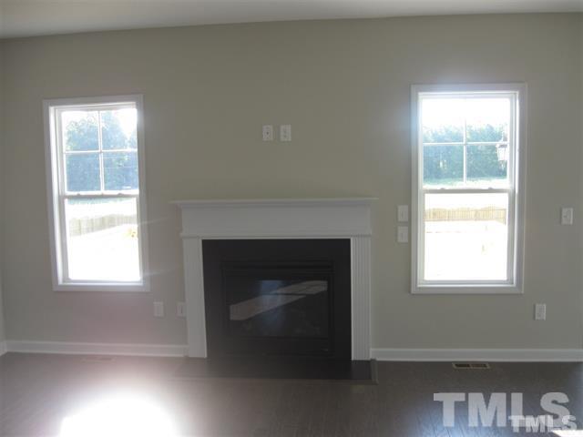10894 Selma Road Middlesex, NC 27557 - Photo 6 of 12 a living room with a fireplace and a window
