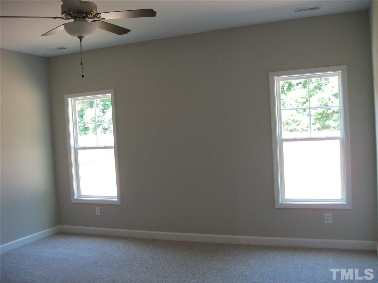 10894 Selma Road Middlesex, NC 27557 - Photo 7 of 12 an empty room with a window and a fan