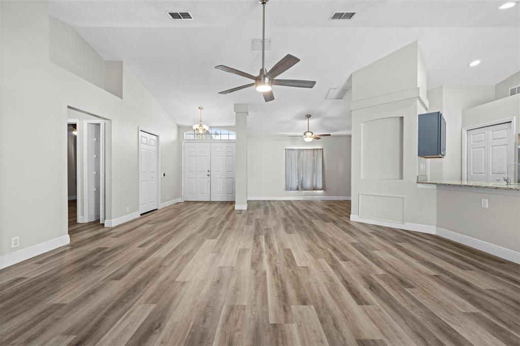 8155 Giffen Lane Spring Hill, FL 34608 - Photo 11 of 52 a view of a livingroom with a ceiling fan wooden floor and a ceiling fan