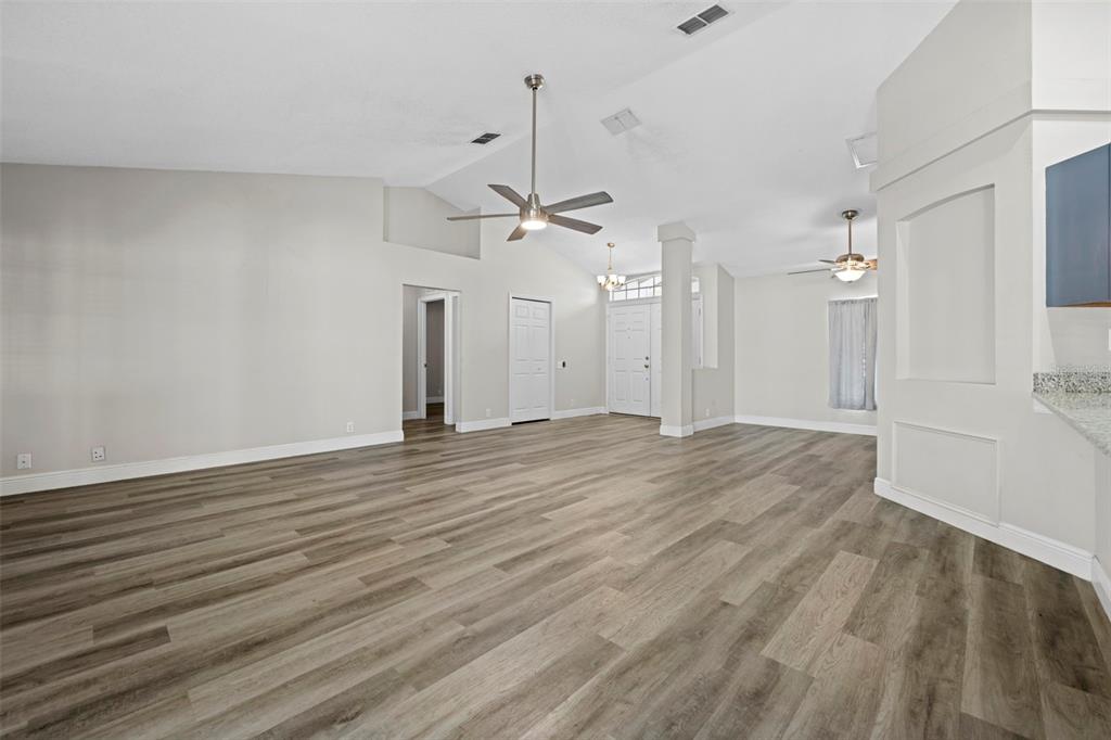 8155 Giffen Lane Spring Hill, FL 34608 - Photo 12 of 52 an empty room with wooden floor and a ceiling fan