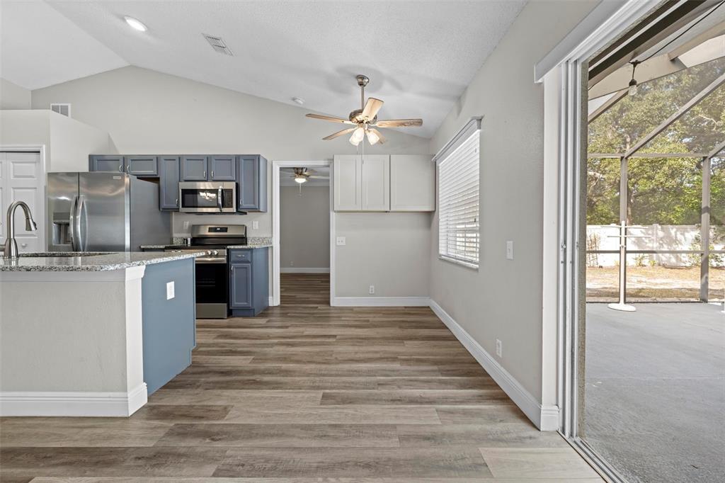8155 Giffen Lane Spring Hill, FL 34608 - Photo 15 of 52 a kitchen with stainless steel appliances granite countertop a refrigerator a sink dishwasher a stove and a refrigerator